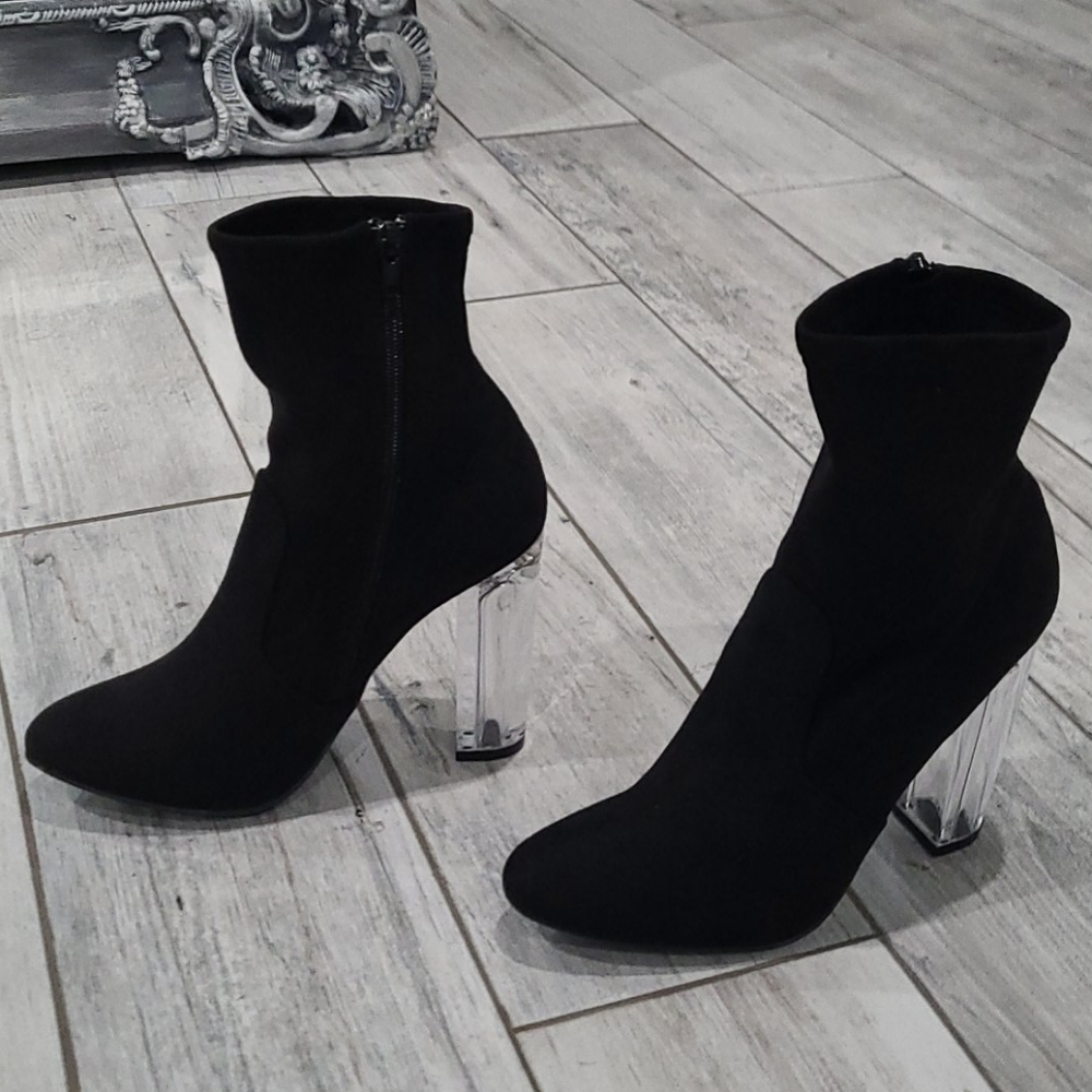Black ankle boot with clear heel.